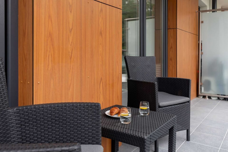 Spacious balcony with outdoor furniture. 