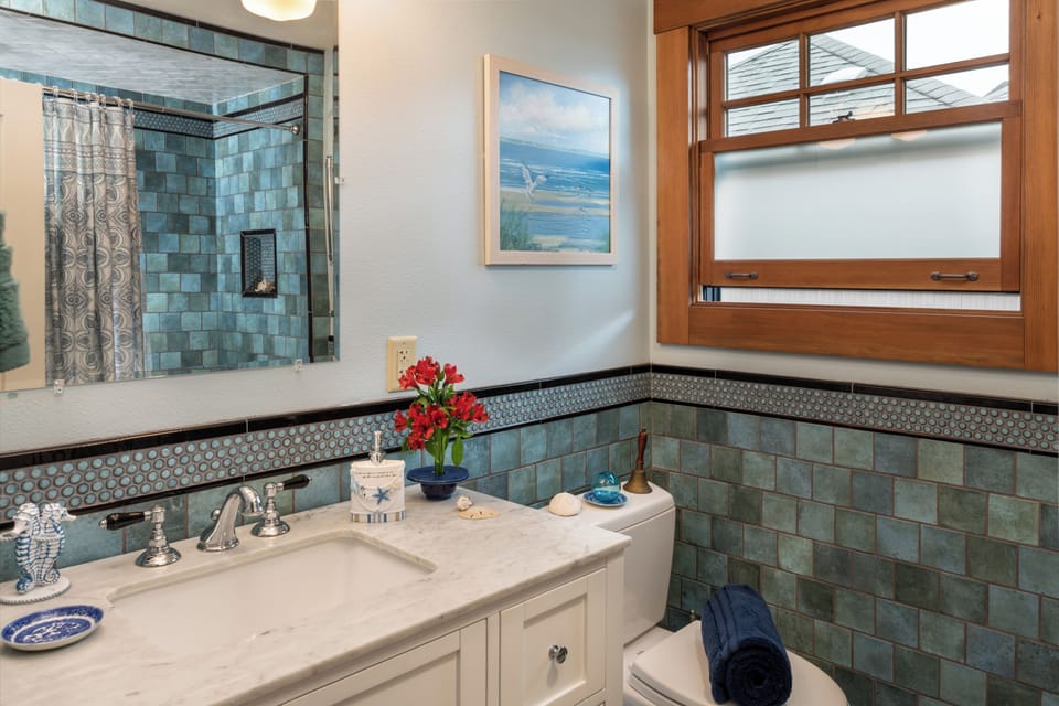2nd bathroom with custom tile & windows . - 2nd bathroom shows unique tile work, new windows and custom tub & showers.