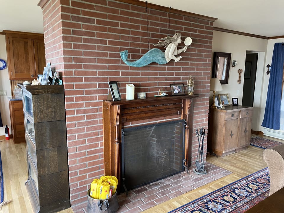 Wood fireplace with a fire log supplied. - Fire log supplied for a cozy fire.