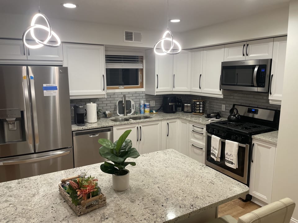 Fully-stocked kitchen with Modern stainless steel appliances 