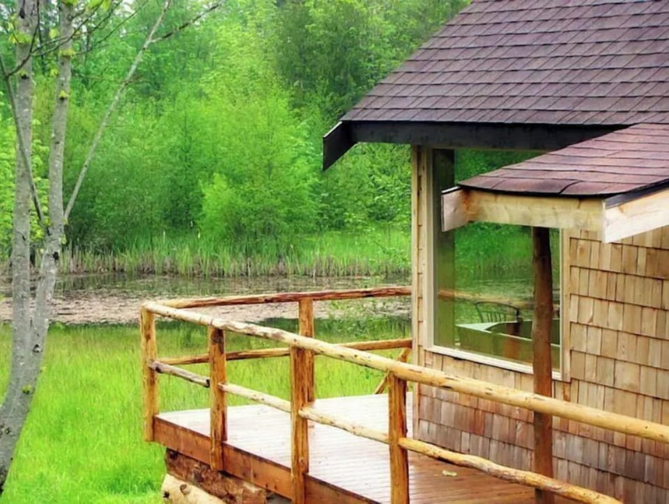 View of the pond, Pond Cabin and surrounding forest. 