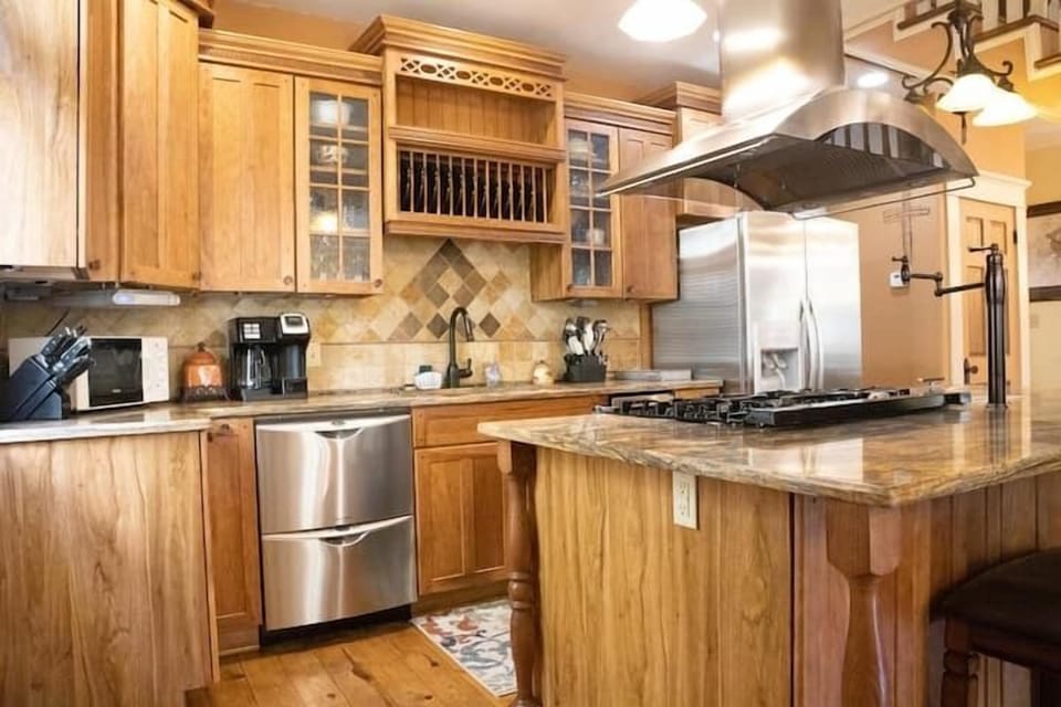 Chef's kitchen fully equipped with 2 dishwashers, gas range and oven, steamer, and pot filler.
