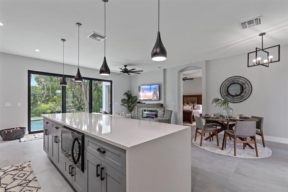 Prepare meals in the stylish main kitchen with a spacious island and stunning pool views.