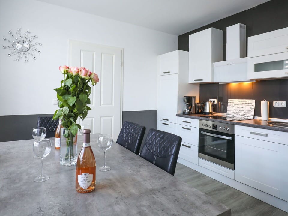 Furniture, Cabinetry, Property, Flower, Countertop, Bottle, Interior Design, Orange, Plant, Kitchen Stove