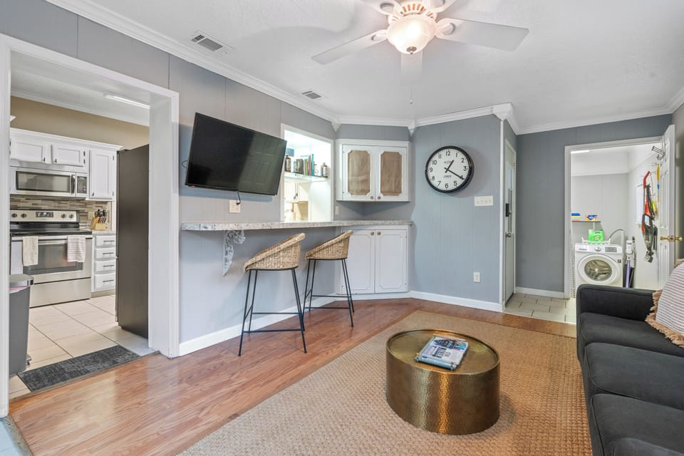 Den with sleeper sofa and desktop computer, access to laundry room