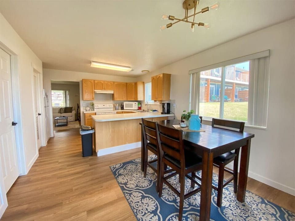 Open-concept living, dining, and kitchen area filled with light
