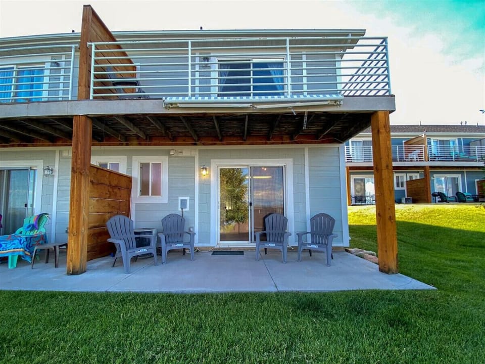 Private patio with seating beneath spacious upper deck