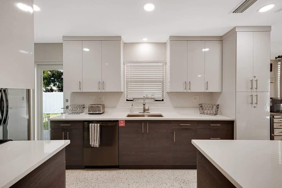 The kitchen is stocked with a full set of appliances including a Keurig and basic kitchen utensils. 