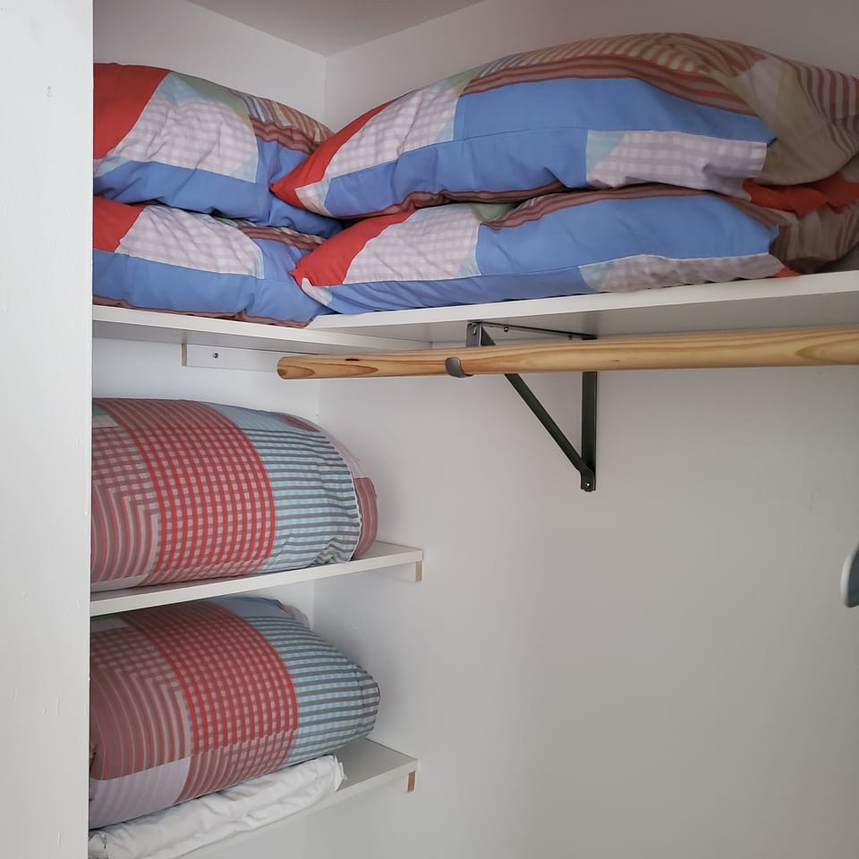 Duvets & pillows for the 2 sleeper sofas stored in the crib & desk bedroom 