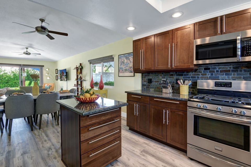 Kitchen features and island with storage and modern appliances.