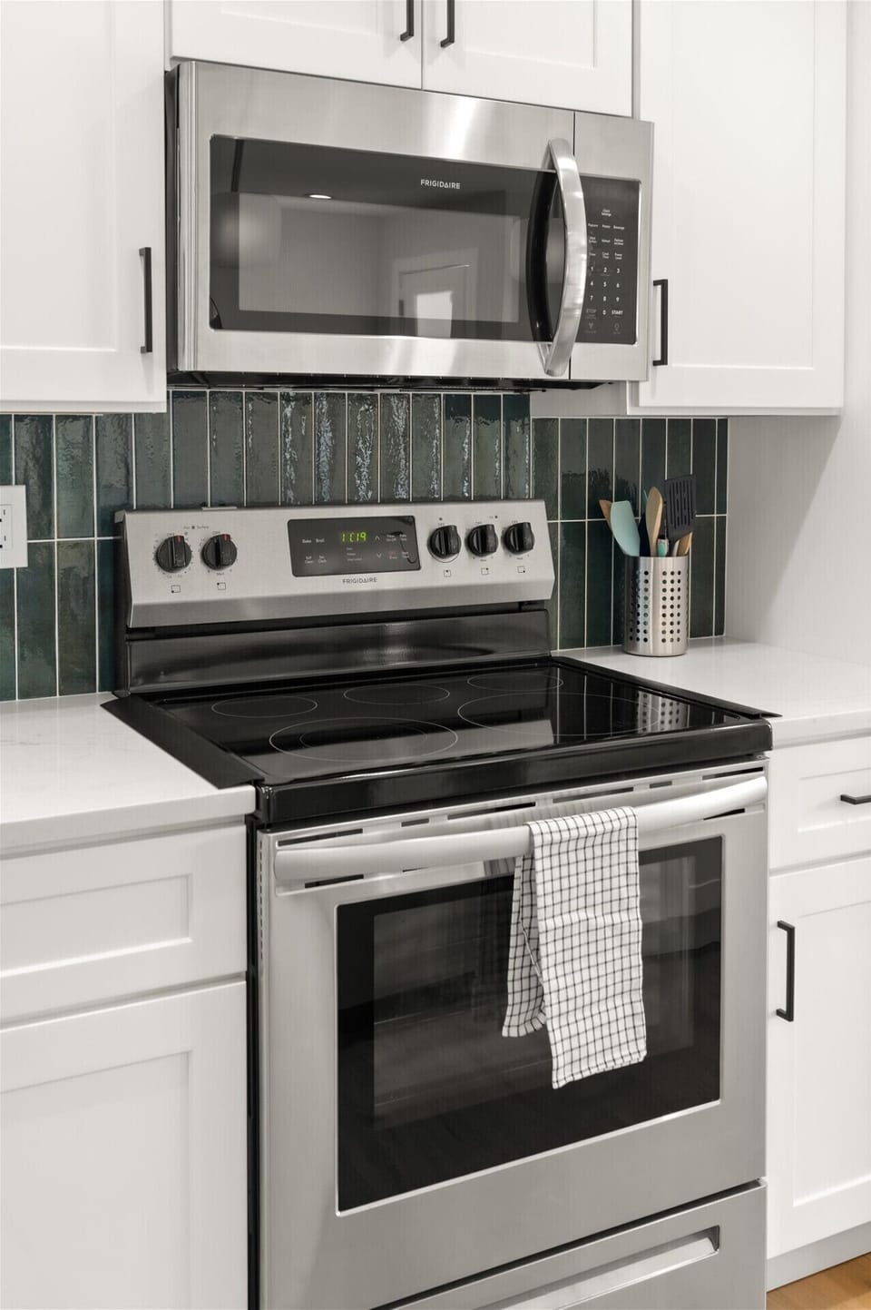Modern glass-top range and clean tile for easy vacation cooking.
