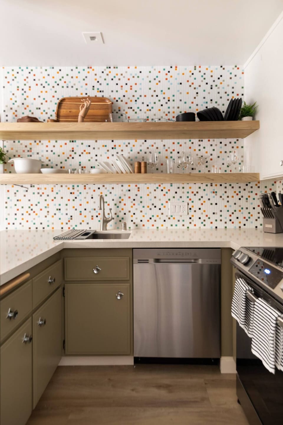 Kitchen with open shelving and new stainless appliances.