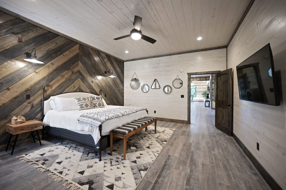 Master Suite: Modern elegance with rustic flair, featuring a king bed and stunning wood accents!
