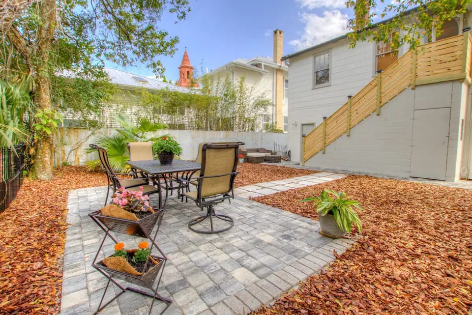 Shared outdoor patio dining area for 6 includes a small grill and fire pit.