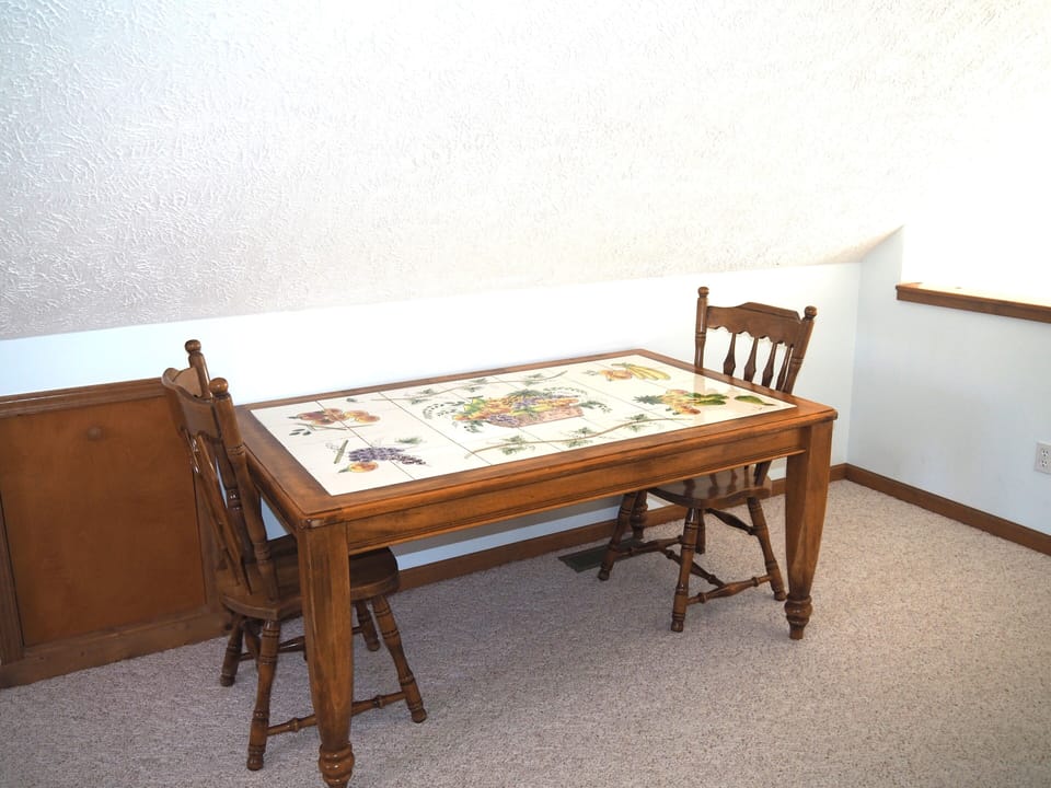 LOFT:  There is a large loft area with a full-size bed, dresser, loveseat, chairs, and table.