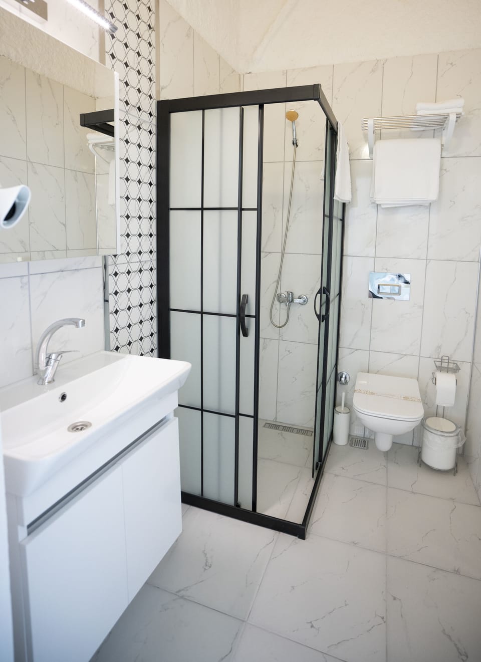 Shower, hair dryer, slippers, towels