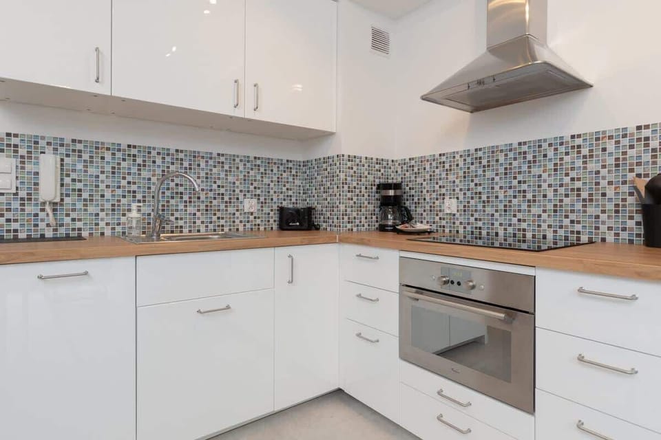 Kitchenette with oven and refrigerator. 