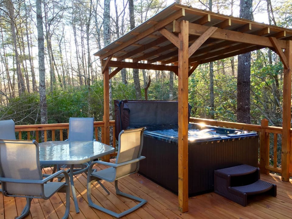Covered 4 Person hot tub and outdoor dining on side deck