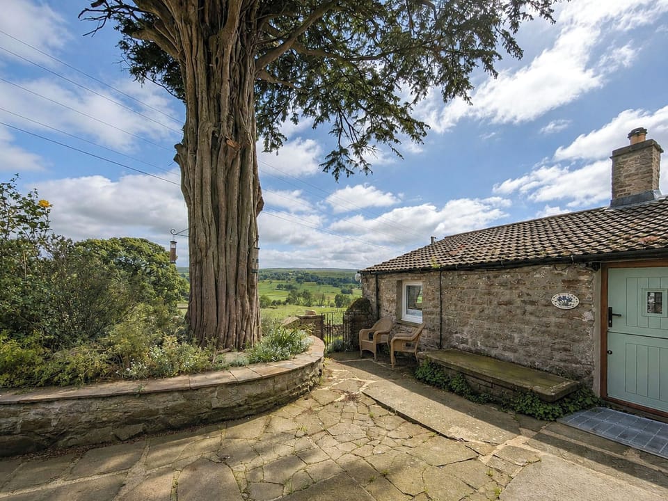Private patio with seating and stunning views across Wensleydale. | Bloomers Bothy, Woodhall, near Askrigg
