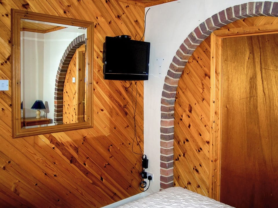 Lovely wood-clad bedroom | Tovey Lodge, Ditchling, near Hassocks