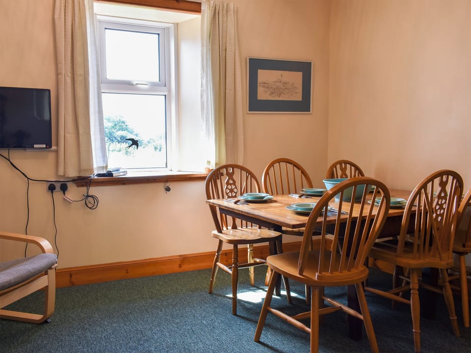 Comfortable living/dining room with wood burner | Burnside Cottage, Sliddery, Isle of Arran