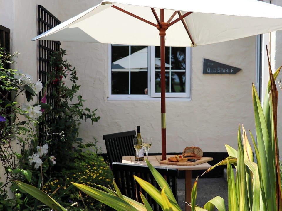 Patio with garden furniture and barbecue | The Old Stable - Cartole Cottages, Pelynt, near Looe
