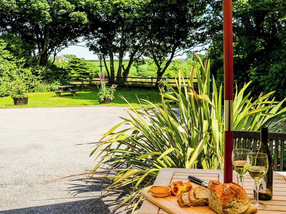 Patio with garden furniture and barbecue | The Old Stable - Cartole Cottages, Pelynt, near Looe