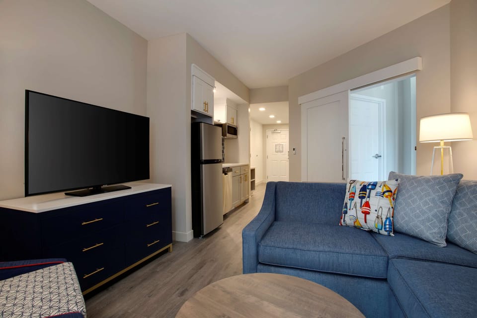 Suite, 1 King Bed | Living area | 55-inch flat-screen TV with cable channels, TV
