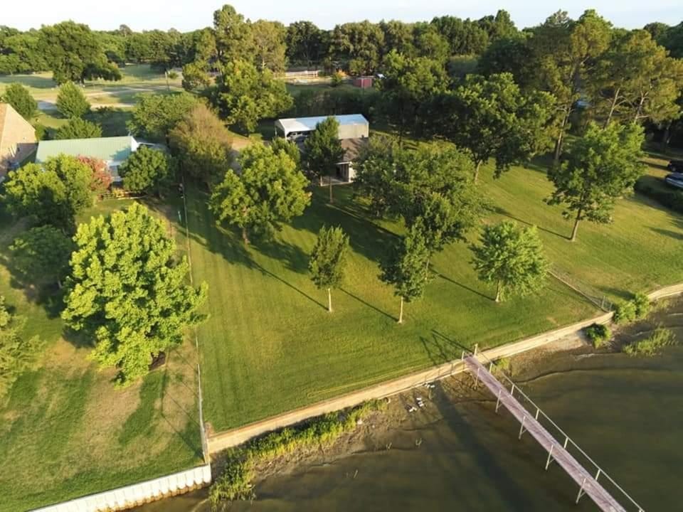 Manicured property with beautiful back yard with nice trees.