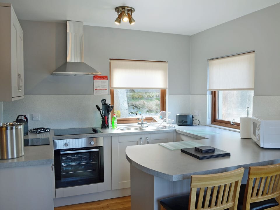 Modern, well equipped kitchen with breakfast bar | Bay Cottage, Gairloch, Wester Ross
