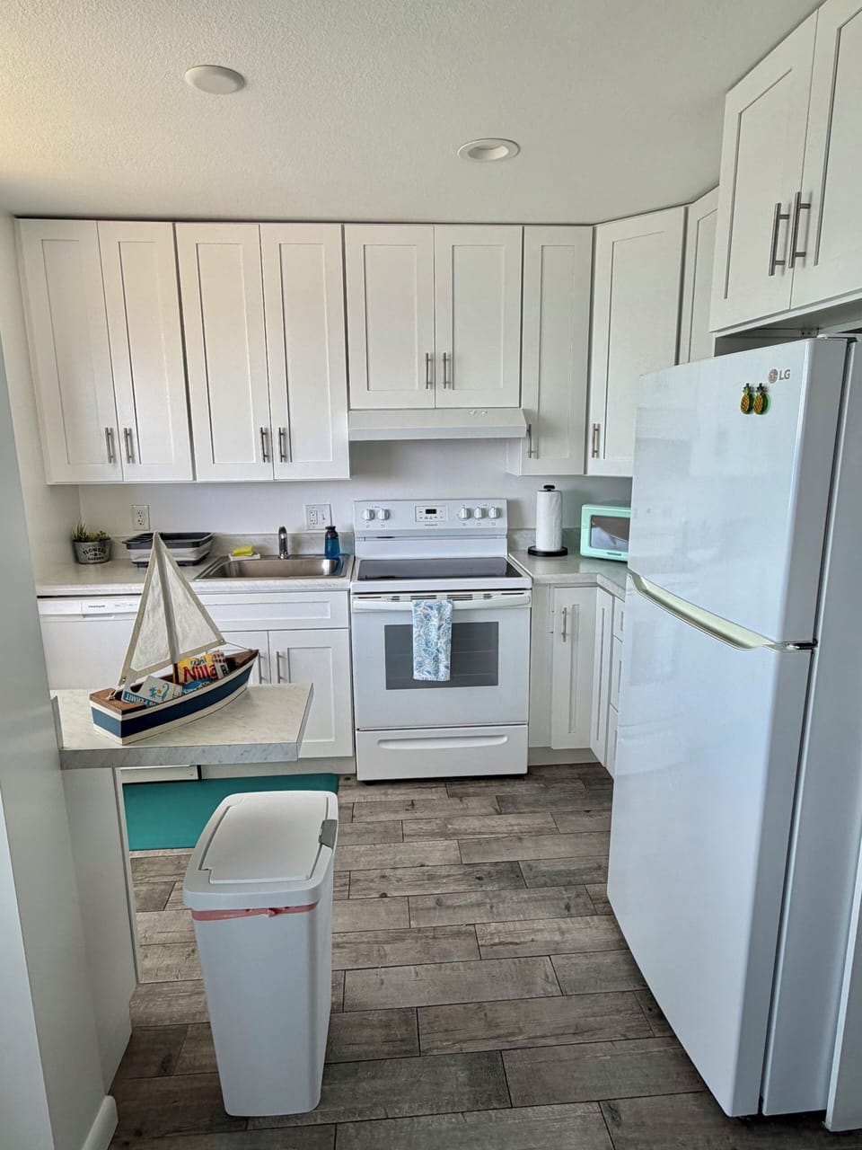 Fully stocked kitchen with toaster, cookware, silverware, dishes