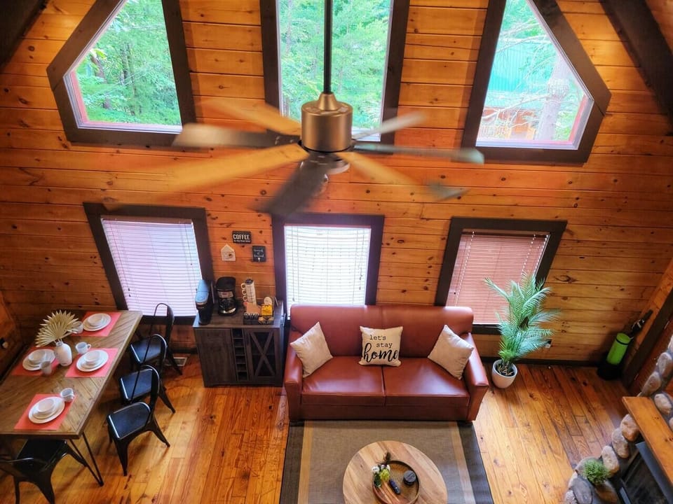 Multiple big windows from ceiling to floor bring in the natural light.  Loft view of the downstairs dining area and living room.