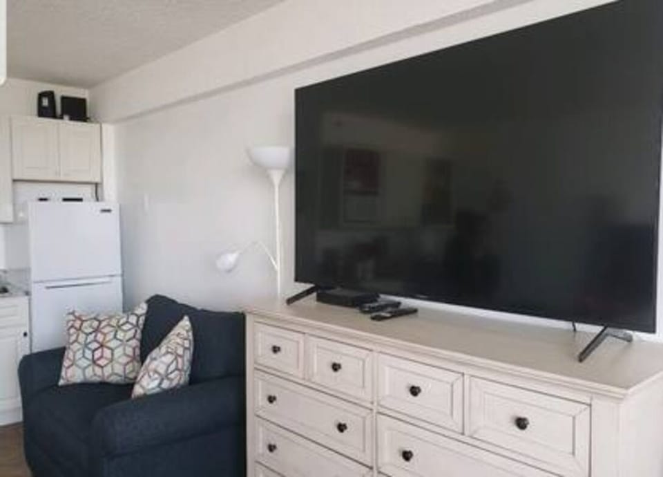 65" in Sony Bravia Ultra-HD Smart TV and cable box on the dresser