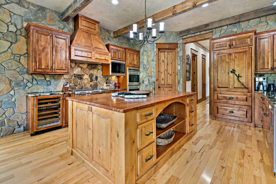 Gourmet kitchen with gas range, double ovens, two dishwashers, wine cooler, and drip-style coffee maker