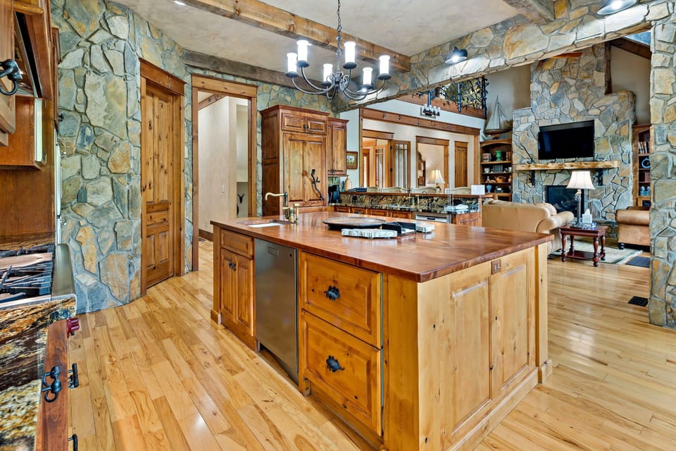 Gourmet kitchen with gas range, double ovens, two dishwashers, wine cooler, and drip-style coffee maker