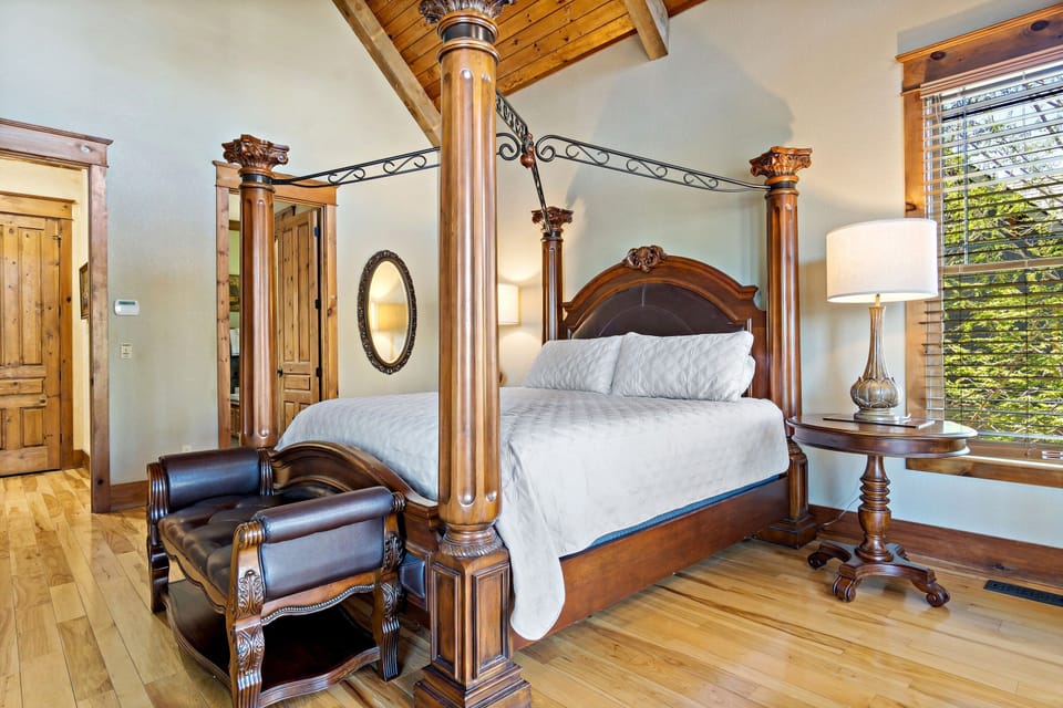 Main floor primary bedroom with private sunroom and en suite bathroom with soaking tub (jets are not usable) and walk-in shower