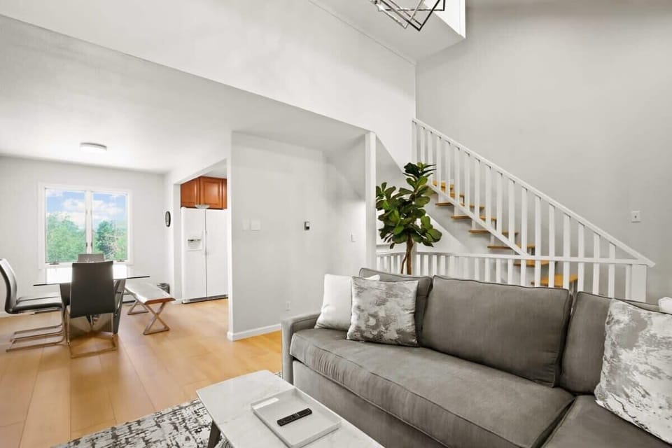 This angle highlights the convenient closeness of the living and dining areas, which has a lovely bay window for natural light and is adjacent to the kitchen.