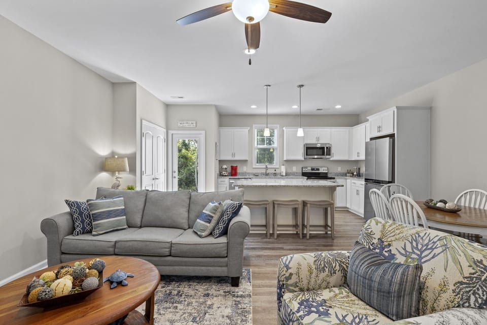 Beautiful furniture - Living room looking toward kitchen with extra seating at the island.
