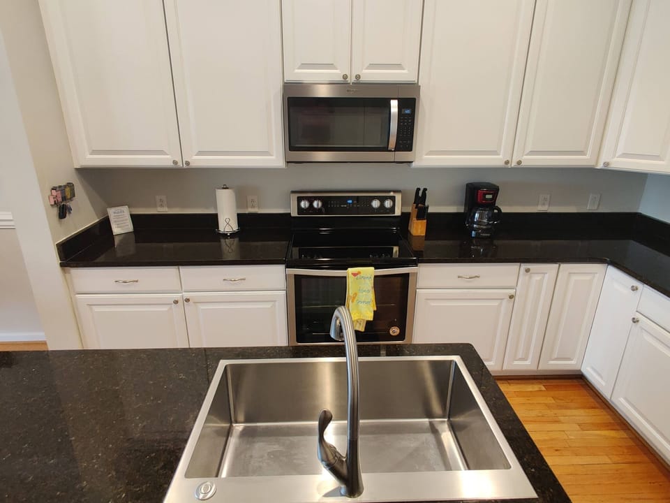 Kitchen has chef's sink and stove with convection oven. 