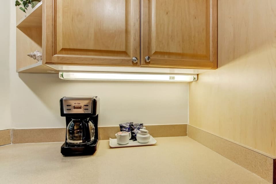 Complimentary 12 cup coffee maker and fixings are provided