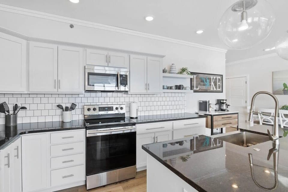 Bright, spacious and every detail adorns the kitchen. The generous kitchen with coffee bar is a perfect gathering place as it opens to the great room, all overlooking the Lake Ozark waters below. Enjoy the coffee bar and a cozy blanket each morning.