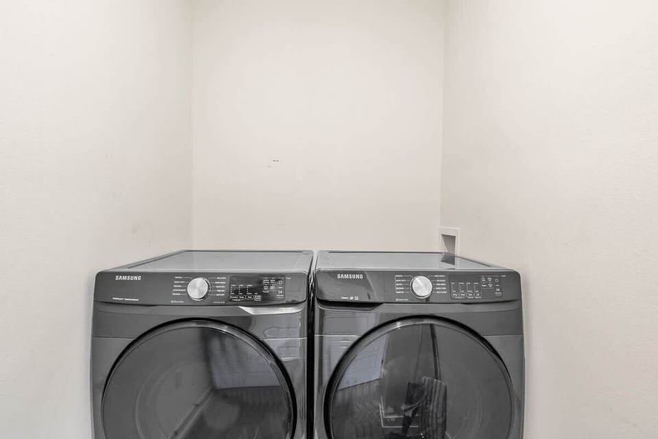 Convenient laundry area featuring a modern washer and dryer in a clean, dedicated space.