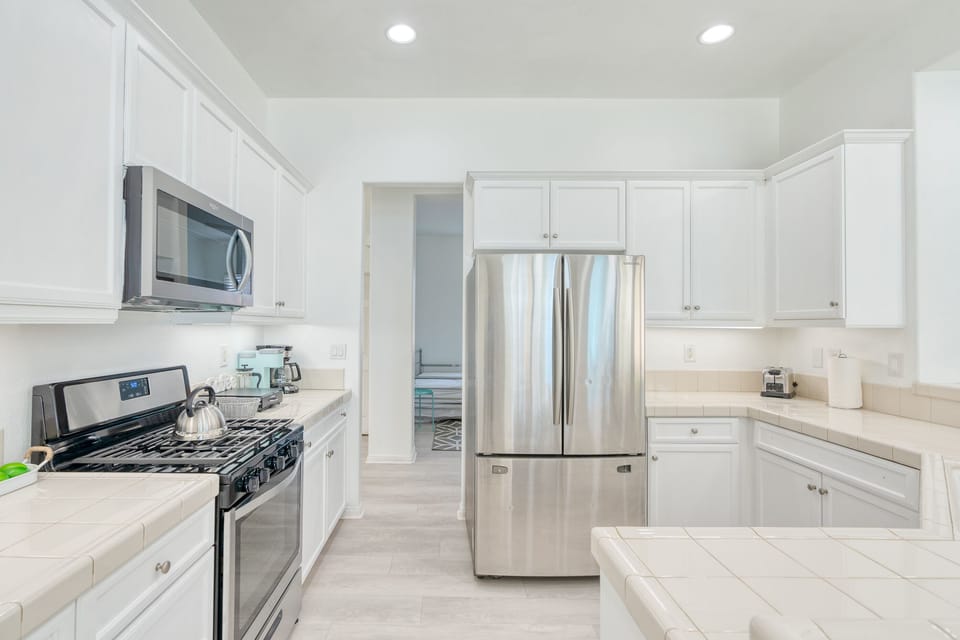 Kitchen with stainless steel appliances: oven/microwave/refrigerator/dishwasher