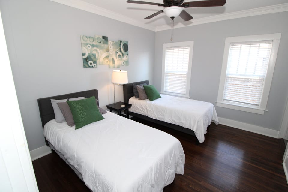 Twin bedroom with dresser and smart TV