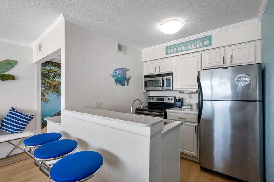In the kitchen, there`s a breakfast nook with 3 chairs