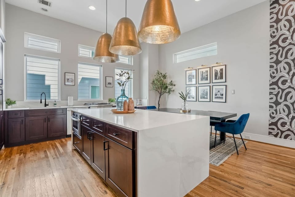 Large kitchen island with 4 barstools, fully equipped with all the kitchen supplies your group needs.