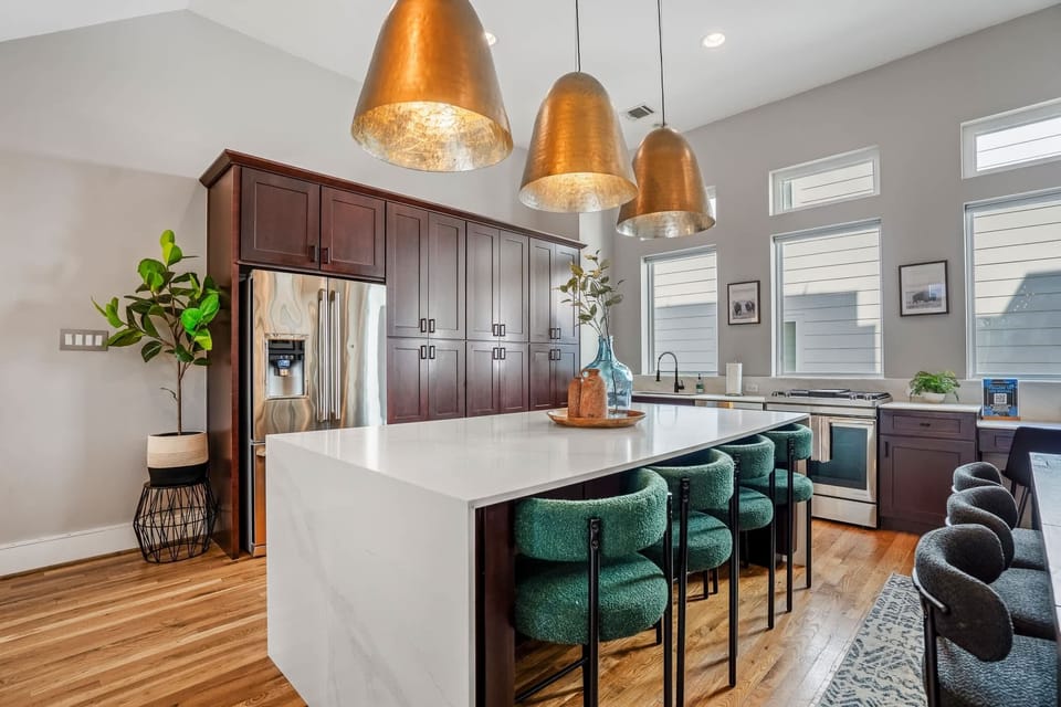 Large kitchen island with 4 barstools, fully equipped with all the kitchen supplies your group needs.
