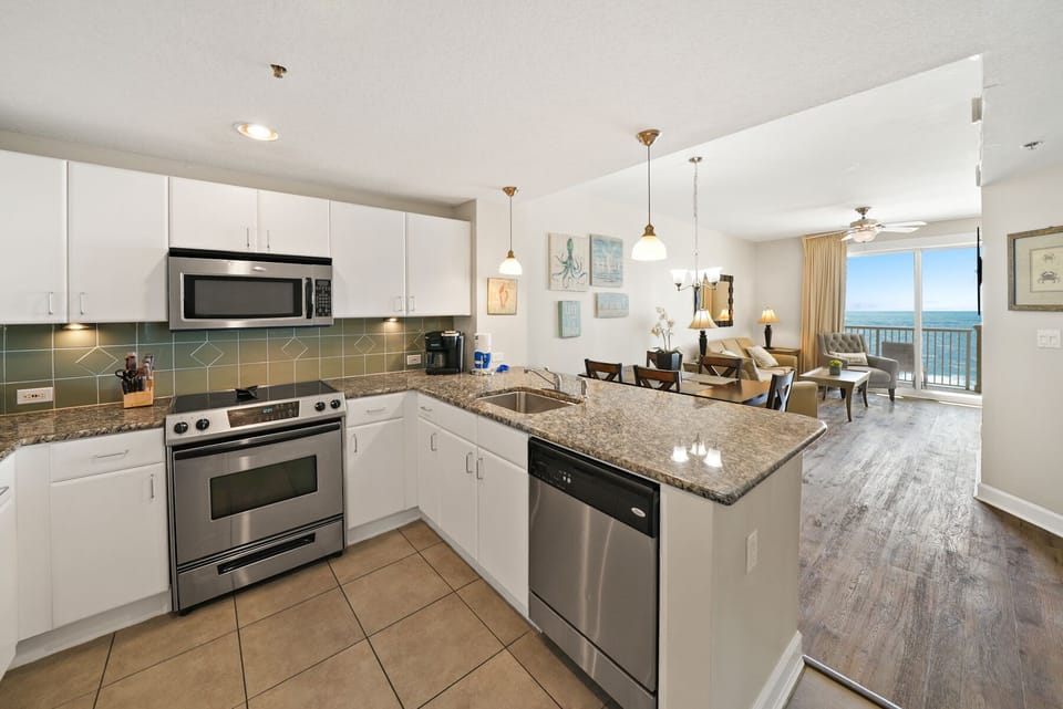 Your fully equipped kitchen opens to a bright living space with stunning ocean views from your private balcony.