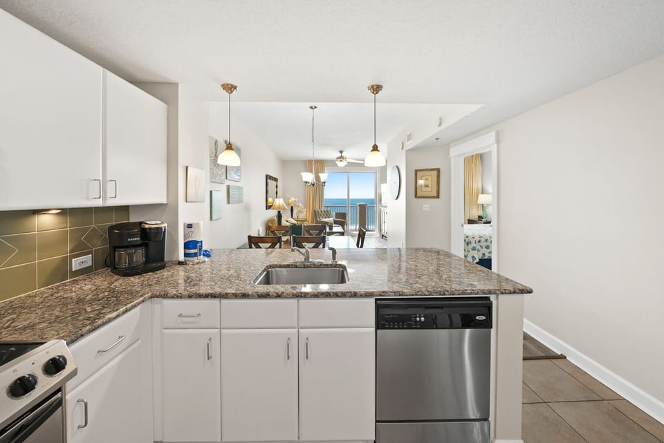 Your fully equipped kitchen features granite counters and stainless appliances, perfectly open to the dining area with stunning ocean views.