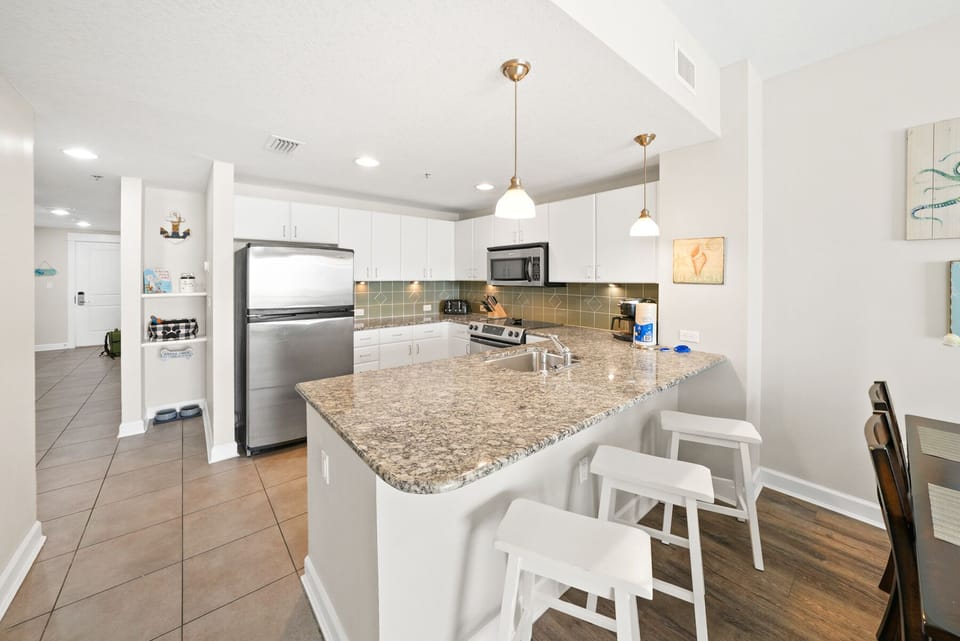 Cook up vacation memories in your fully equipped kitchen featuring granite countertops, stainless steel appliances, and a breakfast bar perfect for morning coffee.